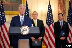 National Security Adviser Robert O'Brien speaks during a news conference on Sept. 21, 2020, at the U.S. State Department in Washington, as Secretary of State Mike Pompeo and Defense Secretary Mark Esper, right, listen.