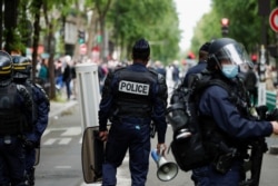 FILE - Police officers stand guard during a protest in support of Palestinians following a flare-up of Israeli-Palestinian violence, in Paris, France, May 15, 2021.