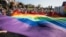 Participants display a large rainbow flag at the "Equality Parade" rally in support of the LGBT community in Lublin, Poland, Oct. 13, 2018. More than 200 Polish schools had planned to take part in “Rainbow Friday,” an anti-discrimination event set for Oct. 26, 2018, but some bowed out following government pressure and threats.
