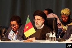 FILE— Iranian President Ebrahim Raisi, centre, attends a meeting during the 2023 BRICS Summit at the Sandton Convention Centre in Johannesburg August 24, 2023.