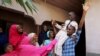 FILE - Muhammed Bello, a rescued student, is carried by his father as his relatives celebrate after he retuned home in Kankara, Nigeria, Dec. 19, 2020. 