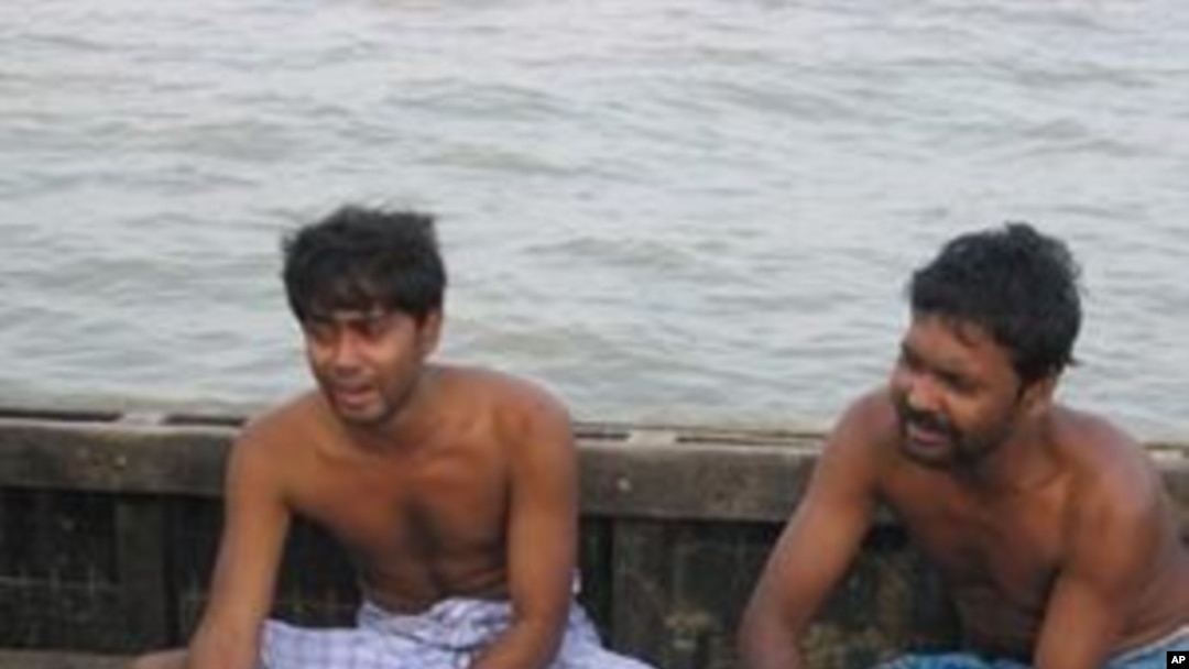 Relatives of a passenger grieve beside the dead body, recovered after an overcrowded ferry capsized near Ghoramara, in Sundarbans Island some 120 Kms (75 miles) south of Kolkata, 30 Oct 2010
