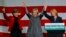 Former United States Secretary of State Hillary Clinton, center, joins U.S. Senator Jeanne Shaheen, a New Hampshire Democrat, left, and New Hampshire Governor Maggie Hassan at a re-election campaign rally in Nashua, New Hampshire, Nov. 2, 2014. 