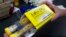 FILE - In this July 8, 2016, file photo, a pharmacist holds a package of EpiPens epinephrine auto-injector, a Mylan product, in Sacramento, Calif. Mylan said it will make available a generic version of its EpiPen, as criticism mounts over the price of its