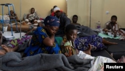 Louise Kanyere sits with her child Jeovanie Mukulu, who has a suspected bullet wound, in the ward at the CBCA Ndosho Hospital in Goma, Democratic Republic of Congo, on Feb. 1, 2025, a few days after the M23 rebel group seized the city.