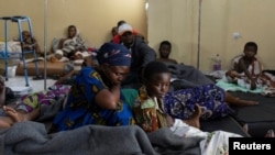 Louise Kanyere sits with her child Jeovanie Mukulu, who has a suspected bullet wound, in the ward at the CBCA Ndosho Hospital in Goma, Democratic Republic of Congo, on Feb. 1, 2025, a few days after the M23 rebel group seized the city.