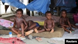 Children sit in a tent at a relief center for flood victims in Patani, Delta state, Oct. 13, 2012.