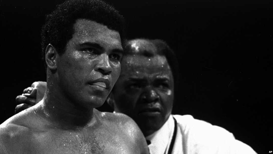 FILE - Muhammad Ali stands with longtime trainer Bundini Brown after Ali became the first man to win the world heavyweight championship three times at the Superdome in New Orleans, September 15, 1978.