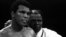 FILE - Muhammad Ali stands with longtime trainer Bundini Brown after Ali became the first man to win the world heavyweight championship three times at the Superdome in New Orleans, September 15, 1978.