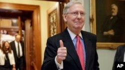 Senate Majority Leader Mitch McConnell of Kentucky signals a thumbs-up as he leaves the Senate chamber on Capitol Hill in Washington, April 6, 2017, after he led the GOP majority to change Senate rules and lower the vote threshold for Supreme Court nominees from 60 votes to a simple majority in order to advance Neil Gorsuch to a confirmation vote.