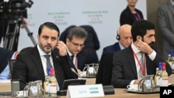 Syrian Interim Foreign Minister Asaad al-Shibani, left, attends the International Conference on Syria at the Ministerial Conference Center in Paris, Feb. 13, 2025.