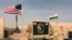 In this photo taken April 16, 2018, a U.S. and Niger flag are raised at the base camp for air forces and other personnel supporting the construction of Niger Air Base 201 in Agadez, Niger. On the edge of the Sahara Desert, the U.S. is building a base for 