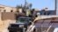 FILE - Soldiers allied to the internationally-backed Government of National Accord return from the frontlines in Tripoli, Libya, April 28, 2019. (H.Murdock/VOA)