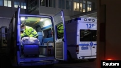 A worker cleans up inside an ambulance outside an emergency department of a hospital, amid the COVID-19 outbreak, in Chengdu, Sichuan province, China Dec. 27, 2022. 