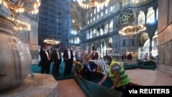 The head of Turkey's Religious Affairs Directorate, Ali Erbas, visits Hagia Sophia as workers lay carpets in its interior, in Istanbul, Turkey, July 22, 2020. (Muhammed Gun/Religious Affairs Directorate/Handout via Reuters)