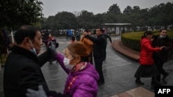 People dance in a park in Wuhan, Hubei province, China, Jan. 23, 2021. 