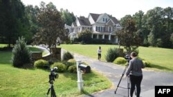 Photographers take photos of the house in Stafford, Va., of Oleg Smolenkov.