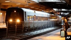 FILE - A temporary fence is erected between tracks at the train station to prevent illegal migrants entering Sweden, at Copenhagen International Airport in Kastrup, Dec. 23, 2015. 