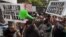 Kenyans demonstrate against Members of Parliament, who last week quietly awarded themselves a $110,000 bonus for five years of service in parliament, Nairobi, Kenya Oct. 9, 2012. 