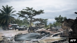 FILE - Burned houses are seen near Beni, Democratic Republic of the Congo, Feb. 18, 2020, after an attack allegedly perpetrated by Allied Democratic Forces. Officials said Jan. 14, 2021, that the group is suspected of another attack killing 46 civilians.