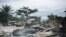 FILE - Burned houses are seen near Beni, Democratic Republic of the Congo, Feb. 18, 2020, after an attack allegedly perpetrated by Allied Democratic Forces. Officials said Jan. 14, 2021, that the group is suspected of another attack killing 46 civilians.
