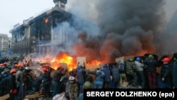 Ukraine -- Protesters hold shields as they clash with riot police during on-going anti-government protests in downtown Kyiv, February 19, 2014