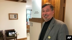 In this photo taken July 3, 2019, Oregon Sen. Brian Boquist poses outside his office in the Oregon State Capitol in Salem, Oregon., after an interview with The Associated Press.