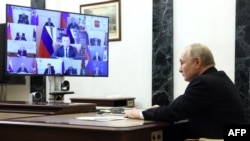 In this photograph distributed by the Russian state agency Sputnik, President Vladimir Putin holds a meeting on measures taken after the massacre in the Crocus City Hall. In the aftermath of the attack, Putin tried to tie the gunmen to Ukraine, which Kyiv flatly denied.