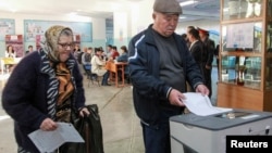 People vote at a polling station during the presidential election in Bishkek, Kyrgyzstan, Oct. 15, 2017.