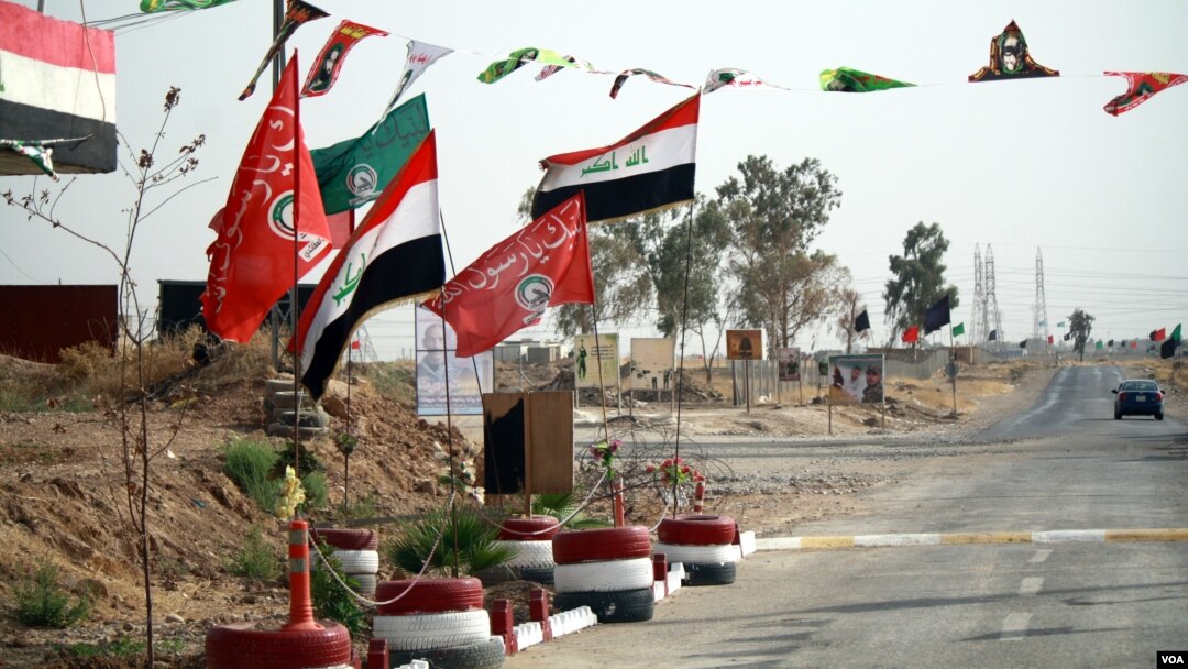 Shia and Iraqi flags adorn Hashd Shaaby bases and were hung with more frequency in the run-up to the Sept. 25 independence referendum, a show of support for Baghdad in the disputed city on Sept. 26, 2017, outside of Kirkuk city. (H. Murdock / VOA)