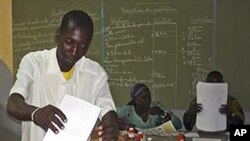 A man cast his ballot during Burkina Faso elections at Ouagadougou, Burkina Faso, Sunday, Nov. 21, 2010.