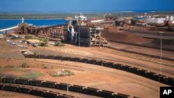 In this undated hand out photo released by BHP Billiton Ltd, shows their iron ore depot in Port Headland, Australia, file photo. 