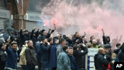 Manchester United fans protest outside the Lowry Hotel where the team was staying, during a protest against the Glazer family, owners of Manchester United, before their Premier League match against Liverpool, in Manchester, England, May 2, 20