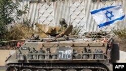 Tentara Israel mengendarai kendaraan militer di sepanjang jalan Kiryat Shmona yang berdekatan dengan perbatasan Lebanon, pada 31 Oktober 2023. (Foto: AFP/Jalaa Marey)