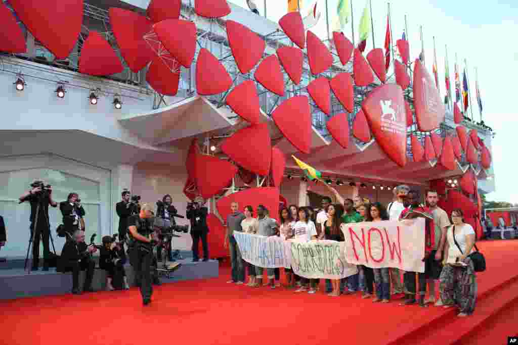 Barefoot marches in support of migrants took place in cities across Italy on Friday.&nbsp; This group reached the red carpet of the Venice Film Festival.
