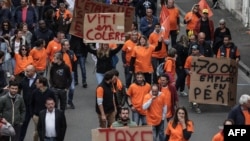 Cognac producers hold placards during a demonstration against Chinese tariff threats, in Cognac, France, Sept. 17, 2024.