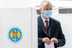 FILE - Incumbent Moldovan President Igor Dodon prepares to cast his vote in the country's presidential elections in Chisinau, Moldova, Nov. 1, 2020.