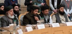 FILE - Mullah Abdul Ghani Baradar, the Taliban's deputy leader and negotiator, and other delegation members attend the Afghan peace conference in Moscow, Russia, March 18, 2021.