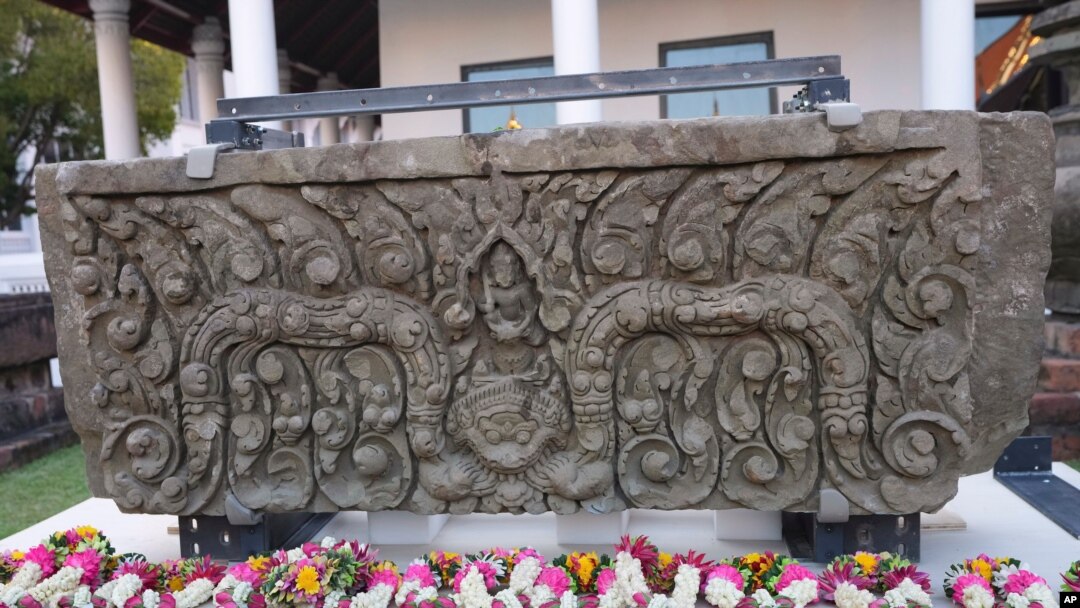 Flower garlands lay in front of a returned sandstone lintel during a welcome ceremony at the National Museum in Bangkok, Thailand, May 31, 2021. 