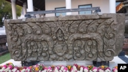 Flower garlands lay in front of a returned sandstone lintel during a welcome ceremony at the National Museum in Bangkok, Thailand, May 31, 2021. 