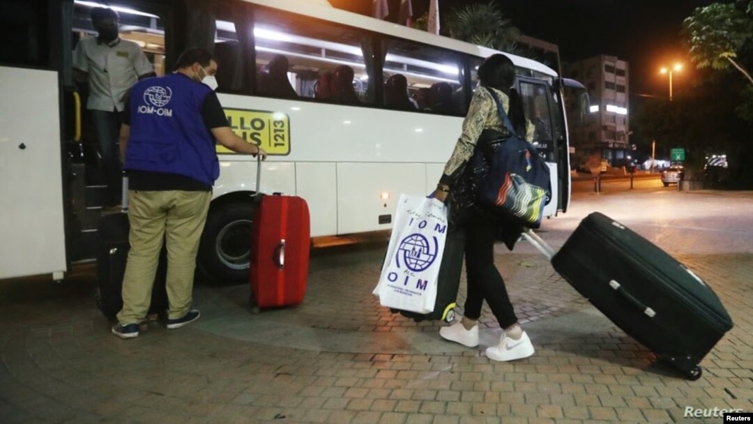 Una trabajadora doméstica migrante de África lleva su equipaje hacia un autobús que la llevaría con otras personas al aeropuerto para regresar a sus países de origen, en un suburbio de Beirut, Líbano, el 5 de octubre de 2020.