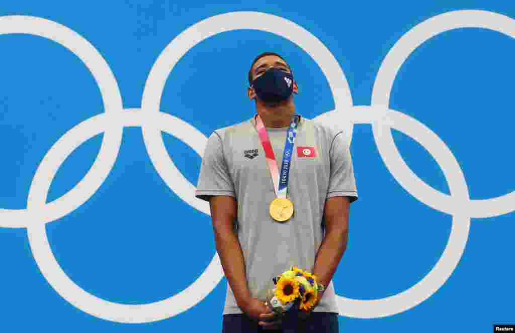 Tokyo Aquatics Centre - Tokyo, Japan - July 25, 2021. Gold medalist Ahmed Hafnaoui of Tunisia on the podium REUTERS/Kai Pfaffenbach