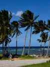 People walk near the beach as Tropical Storm Rafael approaches, in Playa Baracoa, Cuba, November 4, 2024. 