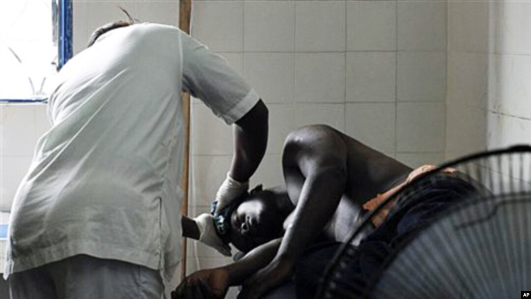 A man receiving treatment at a health clinic after being shot in the hip by security forces loyal to Laurent Gbagbo in the Anyama suburb of Abidjan, March 12, 2011