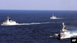 Chinese navy vessels take part in a drill in Zhoushan in east China's Zhejiang province, October 19, 2012.