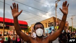 A protester takes part in a demonstration over George Floyd's death in police custody outside the Third Police Precinct on May 27, 2020 in Minneapolis, Minnesota. 