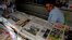 FILE - A vendor sits in his newspaper stand in Buenos Aires, Argentina.