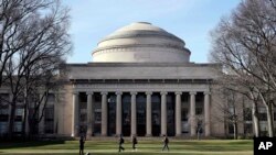 FILE - Students walk past the "Great Dome" atop Building 10 on the Massachusetts Institute of Technology campus in Cambridge, Mass., April 3, 2017. 