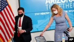 Arizona Gov. Doug Ducey leaves wearing a mask after giving an update on COVID-19 in Arizona during a news conference June 17, 2020 in Phoenix.