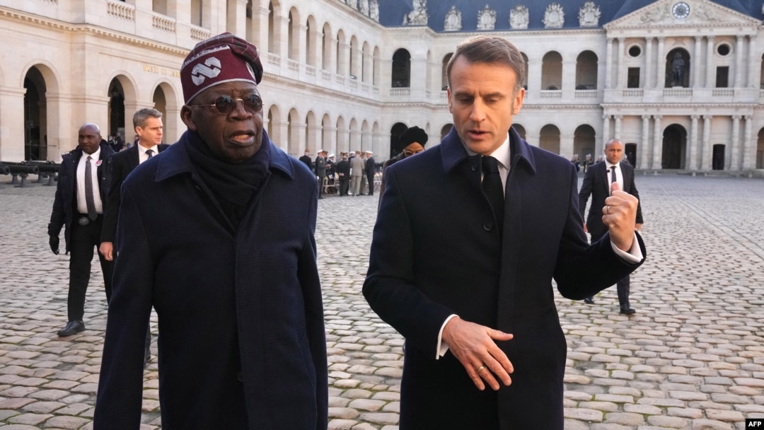 Nigerian President Bola Tinubu and French President Emmanuel Macron review an honor guard during a ceremony in Paris on Nov. 28, 2024, as part of Tinubu's state visit to France.